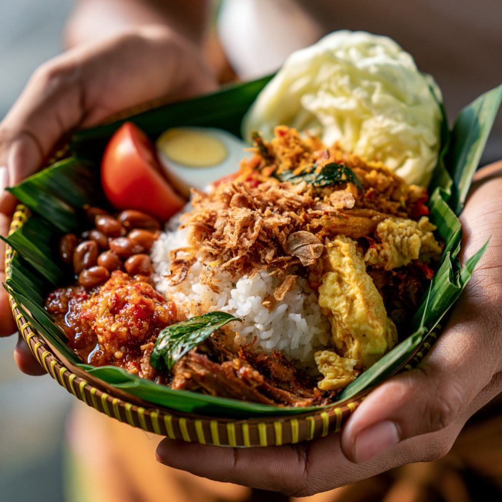 Rice and side dishes served in a banana leaf bowl