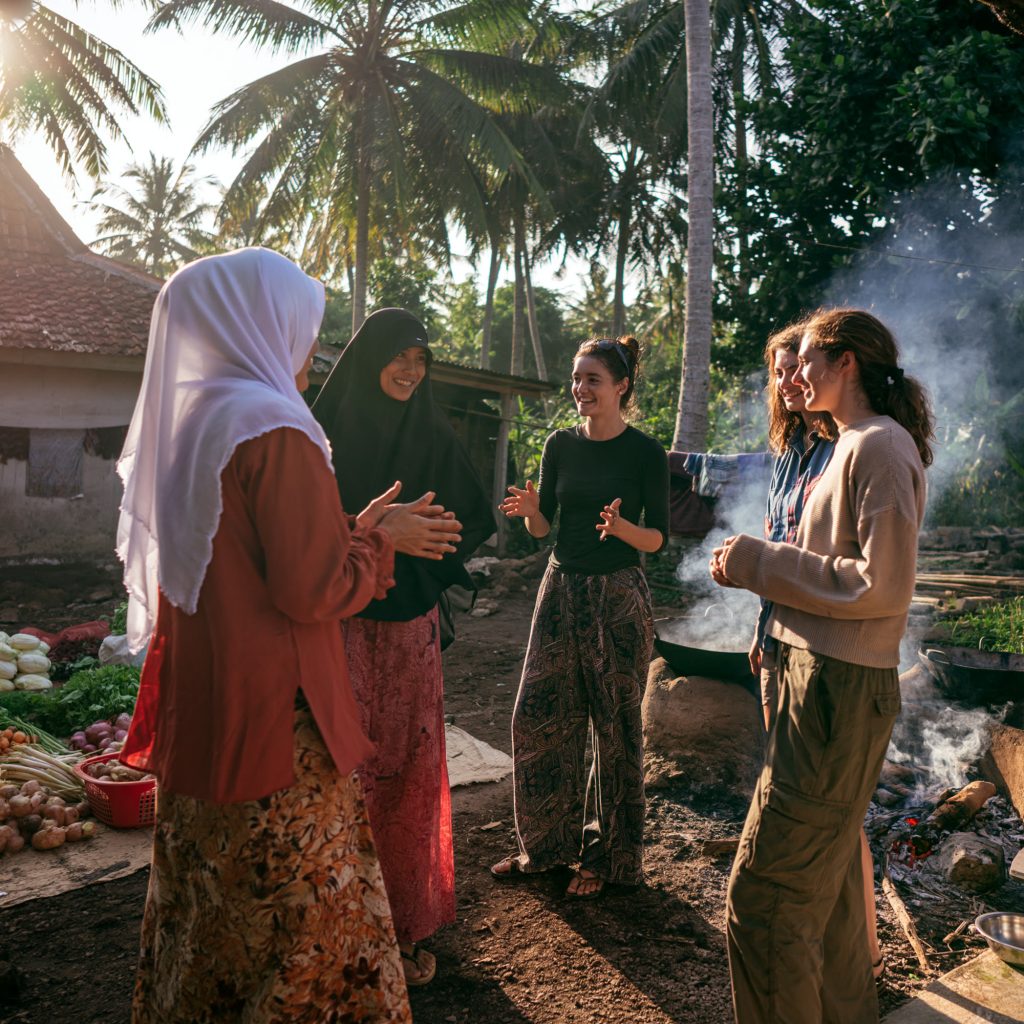 Hosts greeting guests outside their home in Indonesia