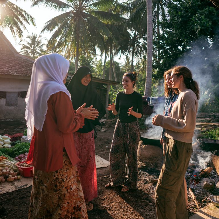 Hosts greeting guests outside their home in Indonesia