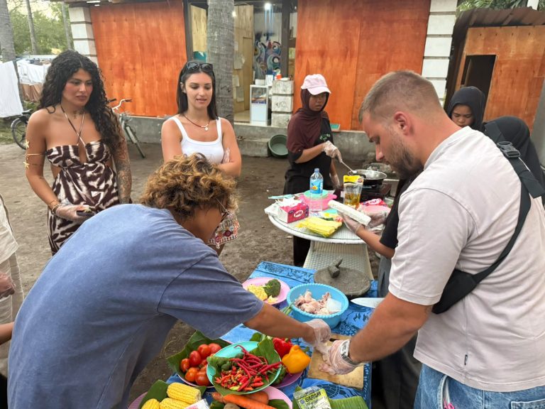 Guests chopping vegetables alongside the host family at the outdoor prep table