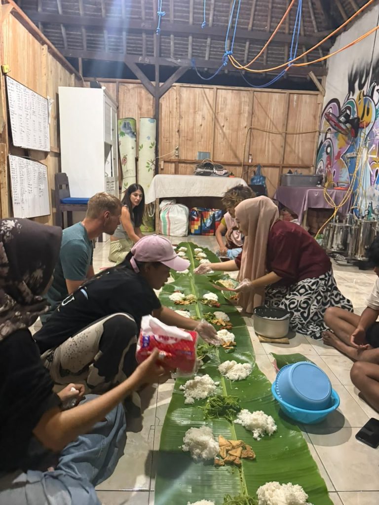 Rice and dishes being served along the banana leaf before everyone sits down